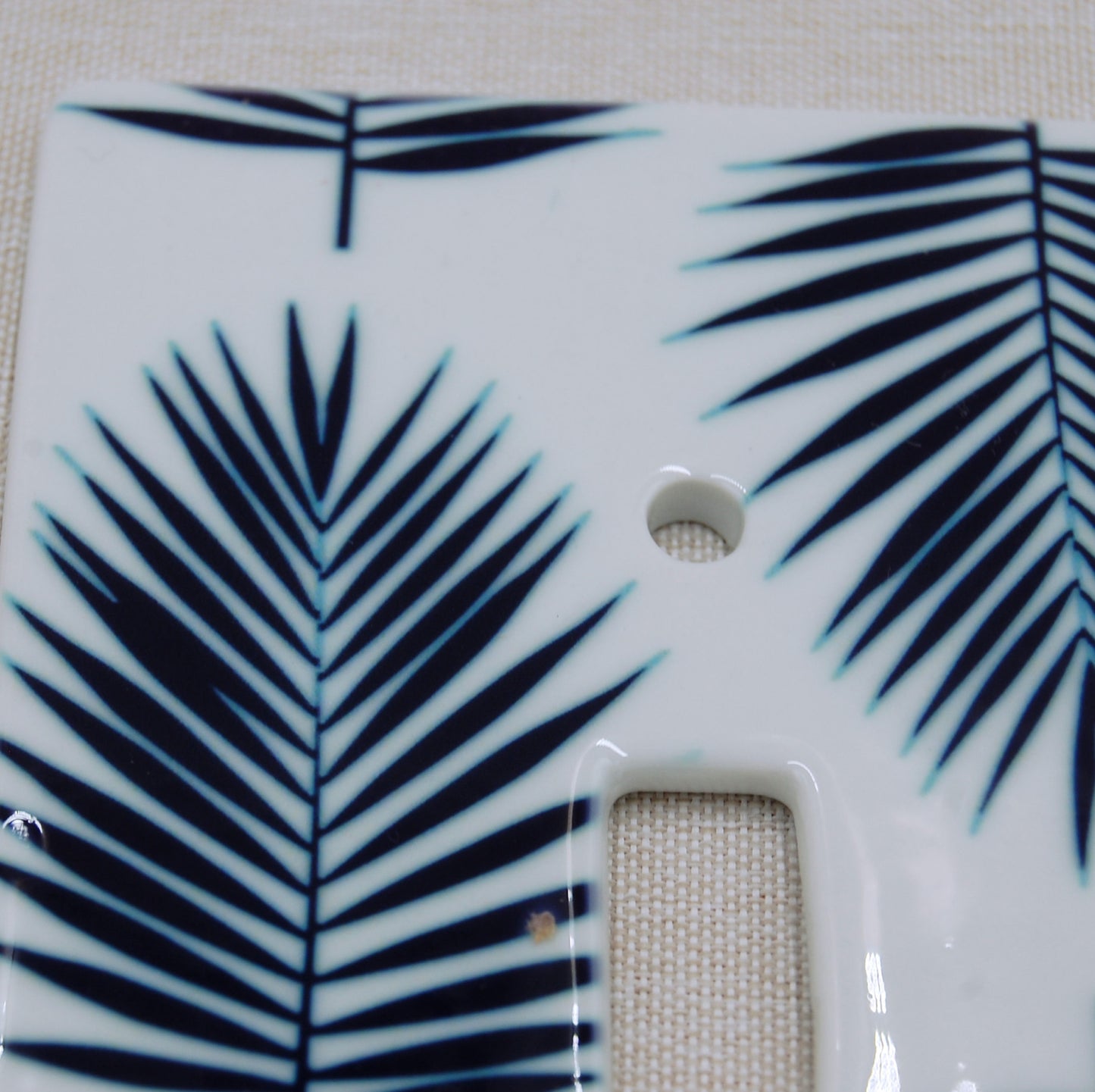 detail shot of the palm porcelain switch plate