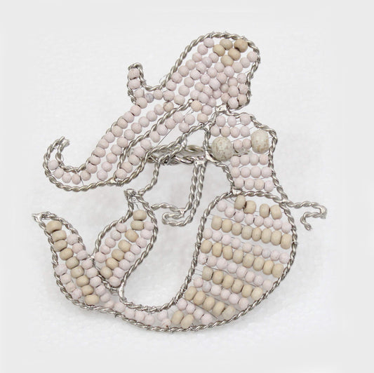 Mermaid shaped napkin ring crafted of natural beads.