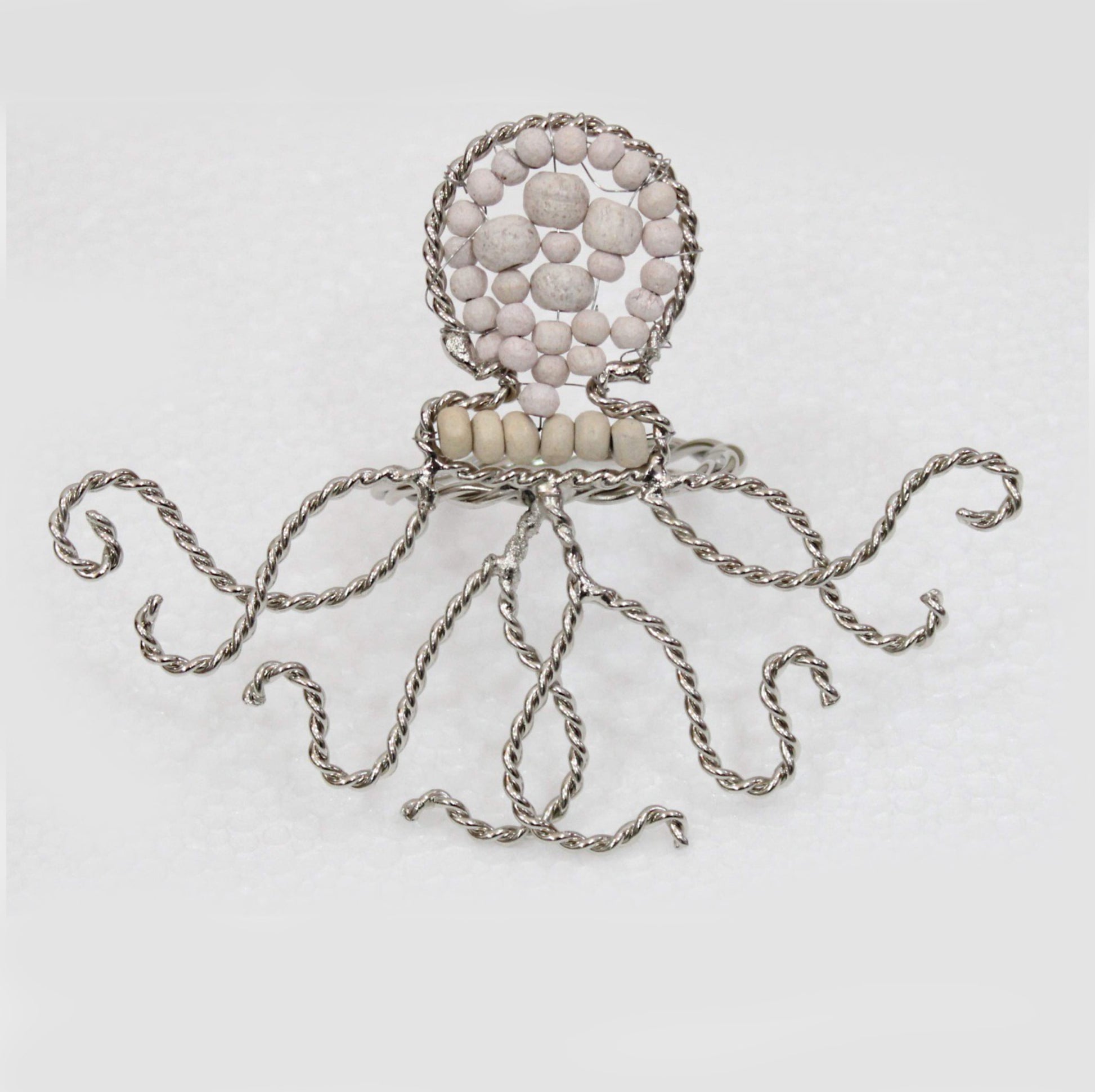 Octopus shaped napkin ring crafted of natural beads.