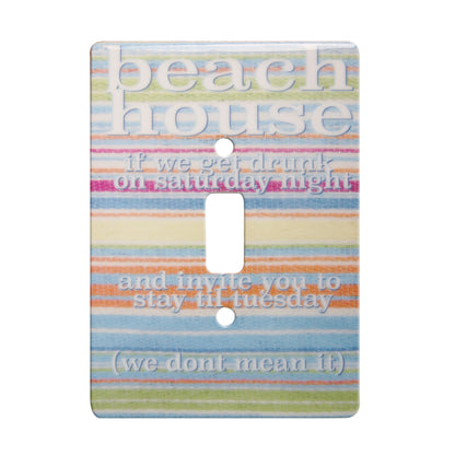 ceramic single toggle switchplate featuring a multi-colored striped background and text that reads "beach house if we get drunk on a saturday night and invite you to stay til tuesday (we dont mean it)".
