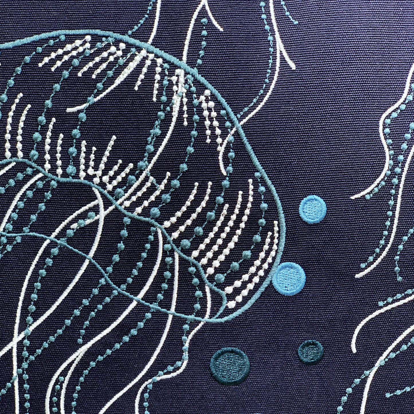 Detail shot of the Jellyfish Bloom Indoor Outdoor Pillow.