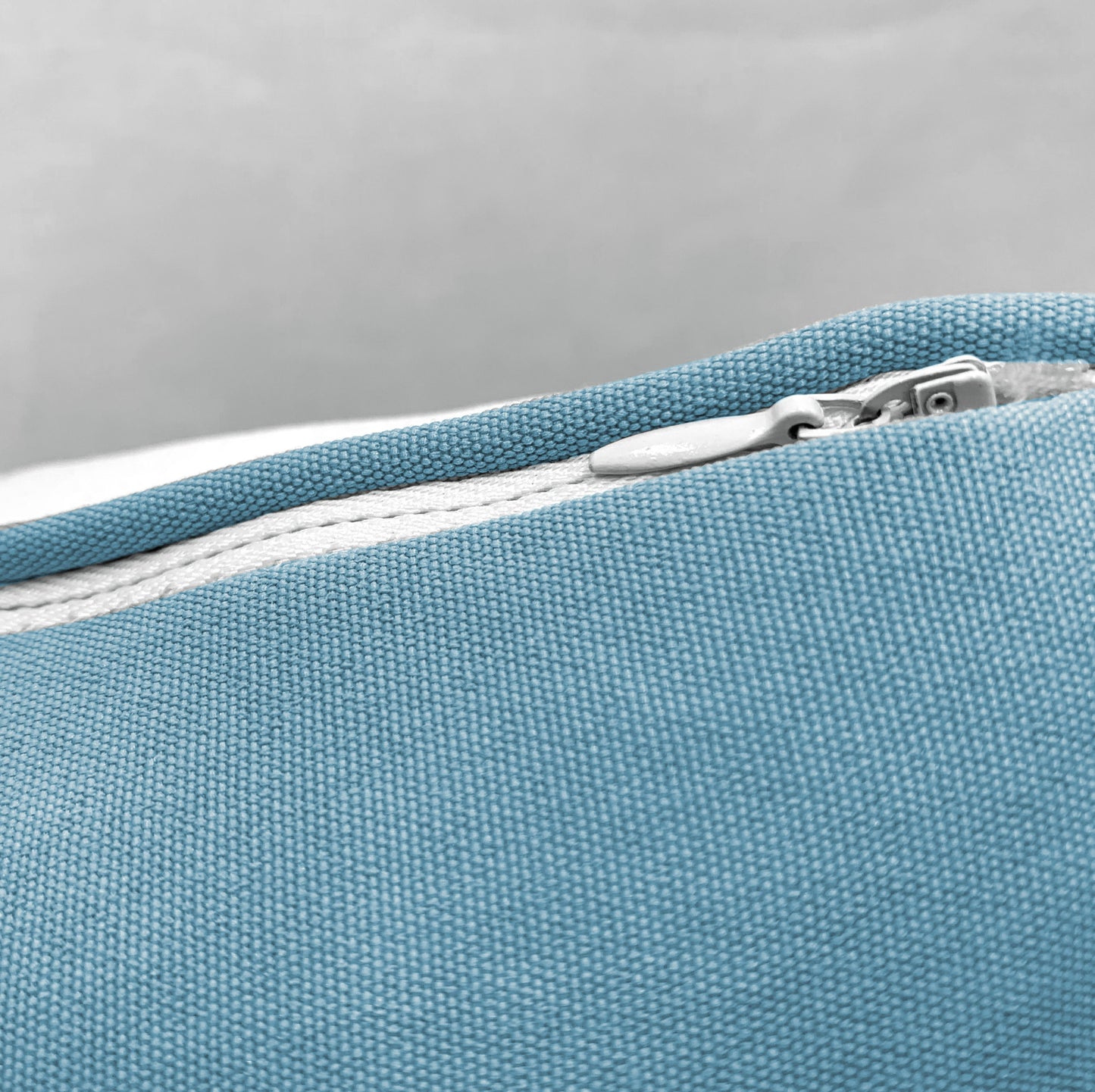 Detail shot of the Kayak Pattern Indoor Outdoor Pillow zipper enclosure.