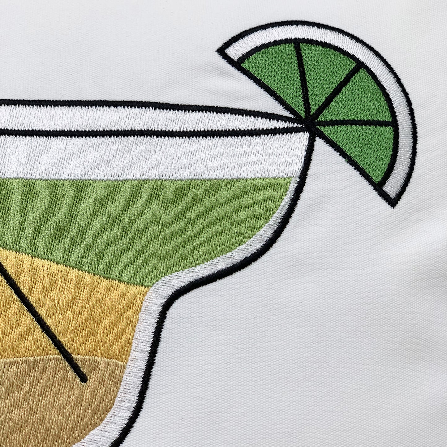 Detail shot of the Margarita Indoor Outdoor Pillow's embroidery work.