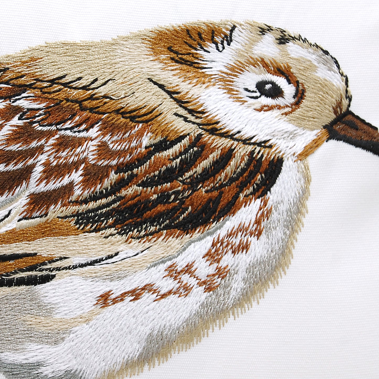 Detailed shot of the Piper Sprinting Right Pillow embroidery work.