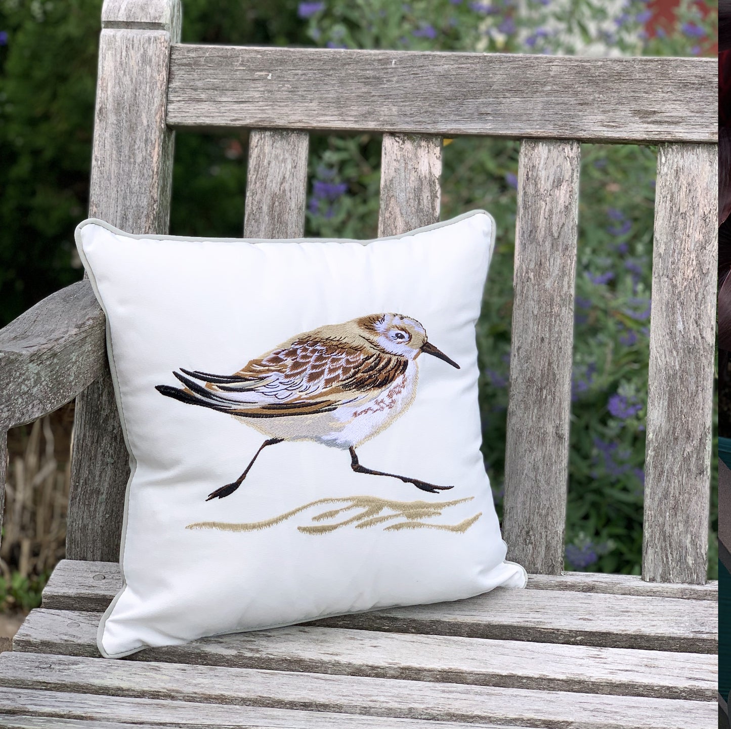 Sandpipe Spring Right pillow styled on a garden bench.
