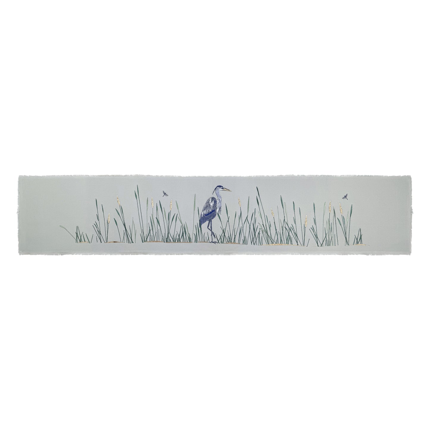 Grey cotton fringed table runner featuring embroidery of Great Blue Heron and reeds.