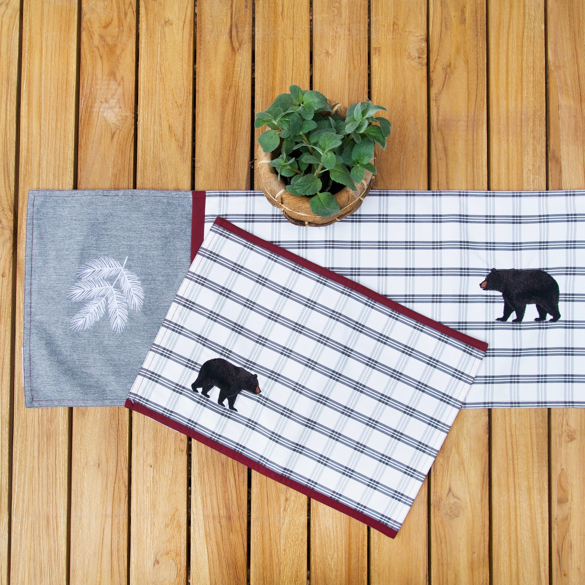 Bear Lodge Outdoor Tabletop on a table outside with a plant