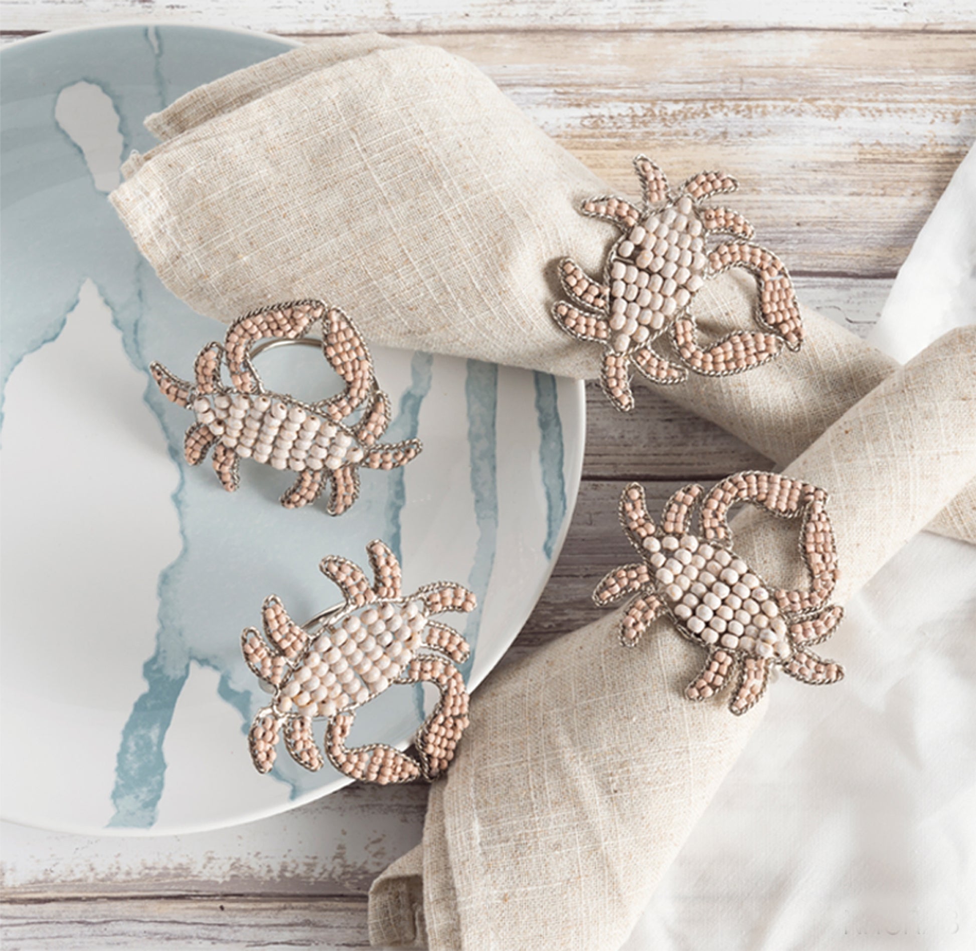 4 crab shaped napkin rings crafted of natural beads.