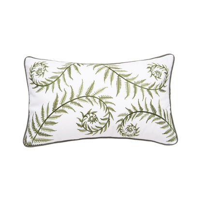 White pillow with green fern branches across the pillow