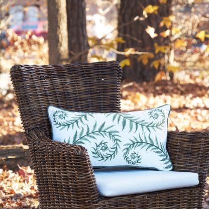 Fiddlehead Fern Lumbar Pillow on a chair outside