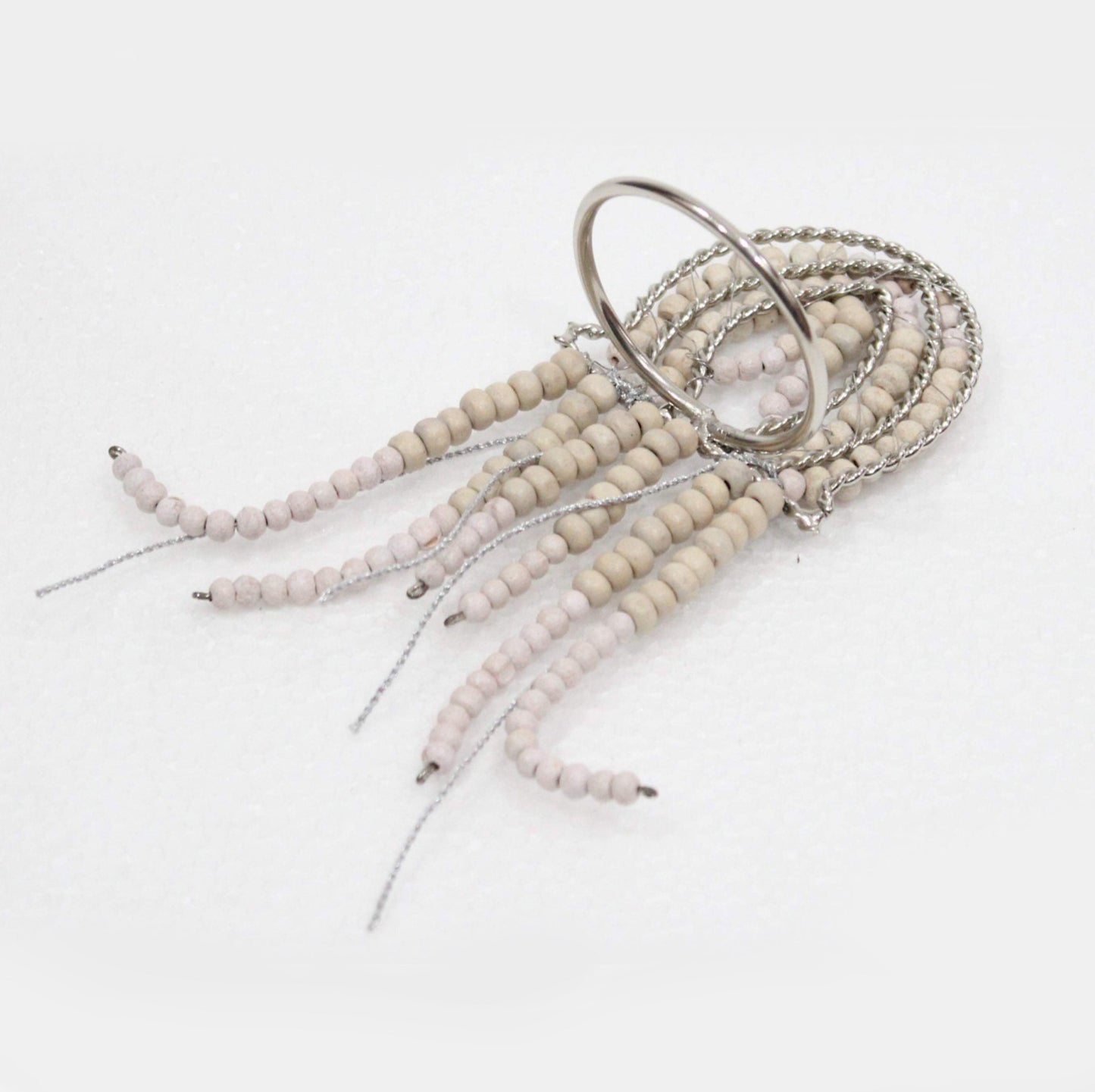 Jellyfish shaped napkin ring crafted of natural beads.