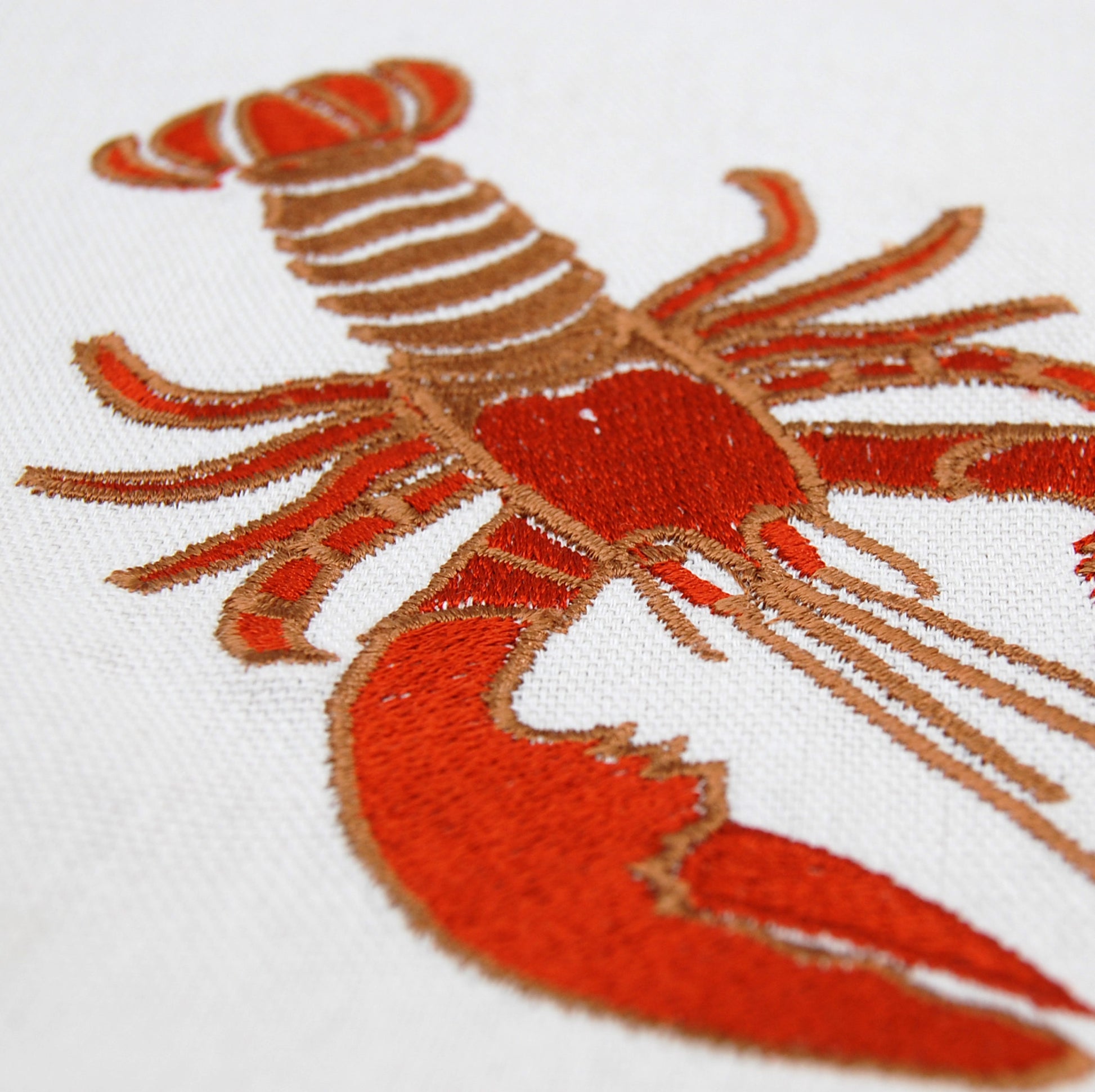 zoom on embroidered red lobster icon.