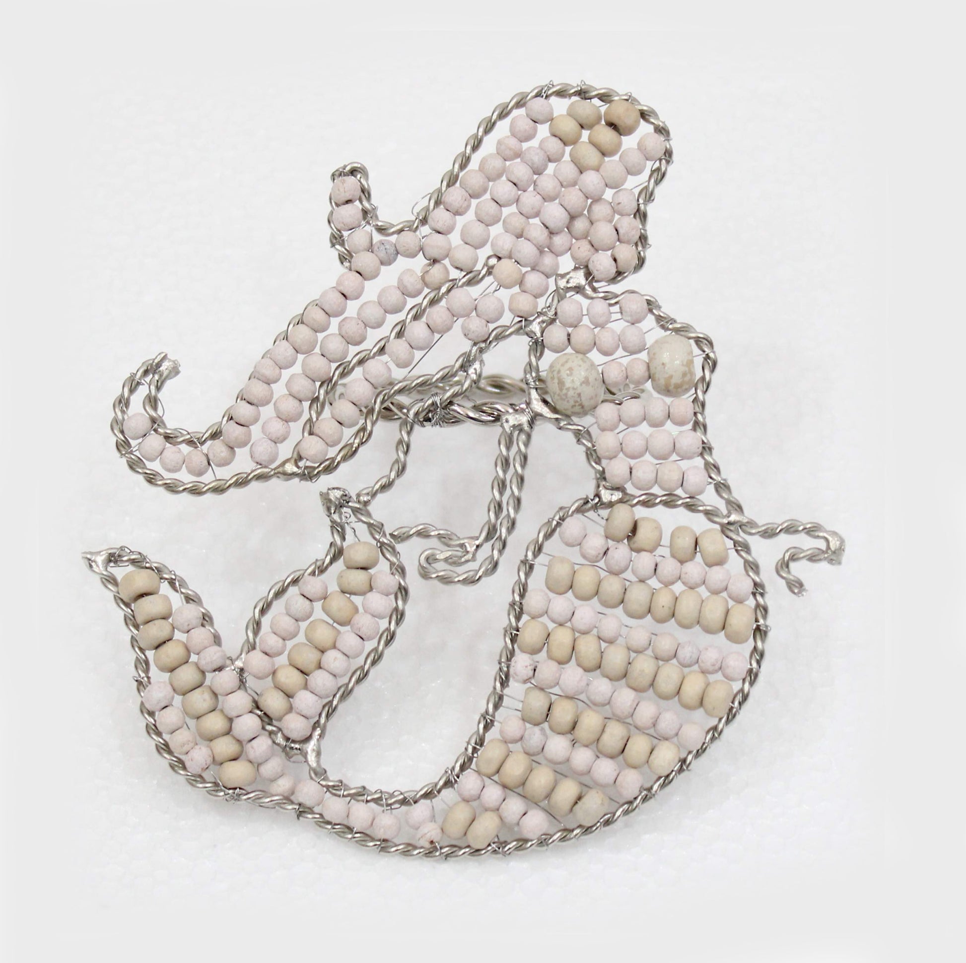 Mermaid shaped napkin ring crafted of natural beads.