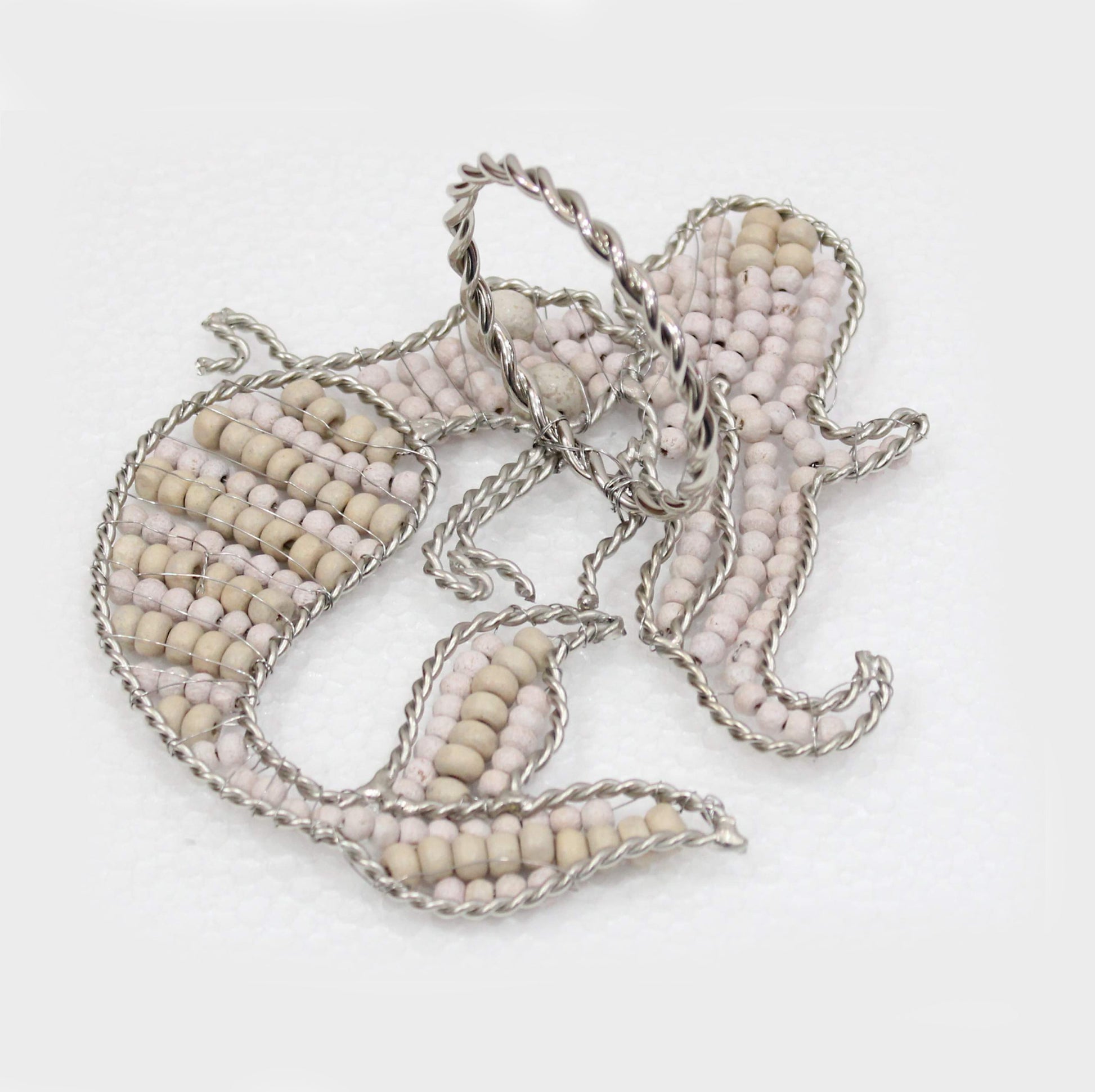 Mermaid shaped napkin ring crafted of natural beads reverse view.