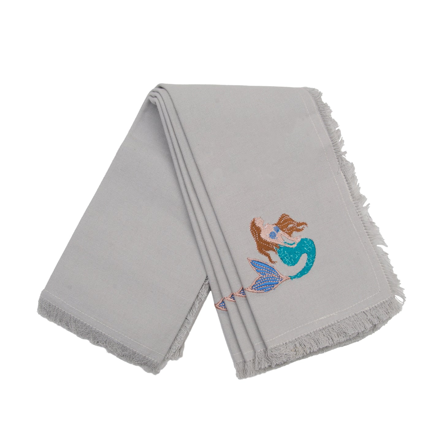 Fringed grey cotton napkins, featuring an embroidered mermaid with brown hair and a turquoise tail.