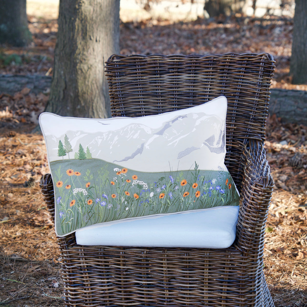 Mountain Wildflowers Lumbar Pillow in a chair outside