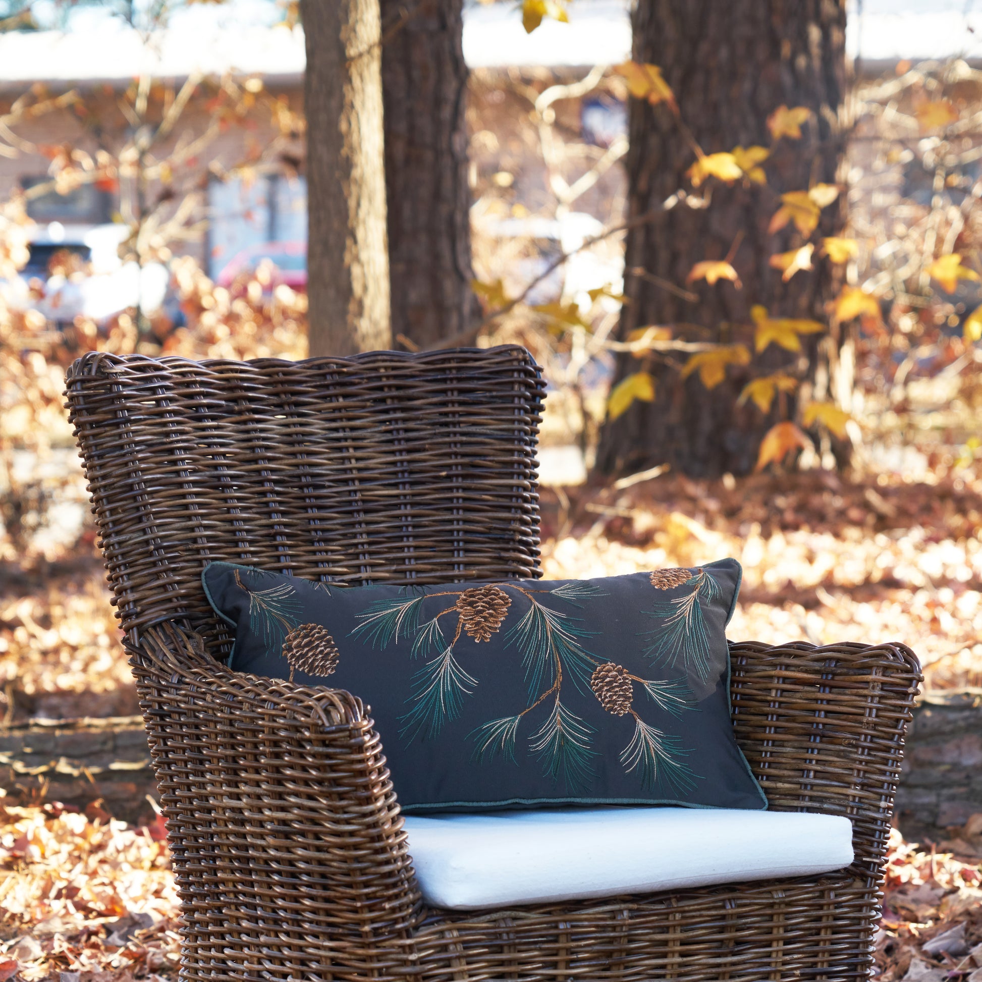 Pine Branch Pattern Lumbar Pillow on the chair outside