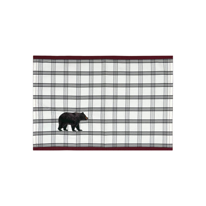 White placemat with grey plaid and a black bear in the right corner featuring a red border on the top and bottom