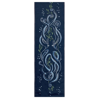 Octopus and seaweed embroidered on a deep ocean blue cotton panel.