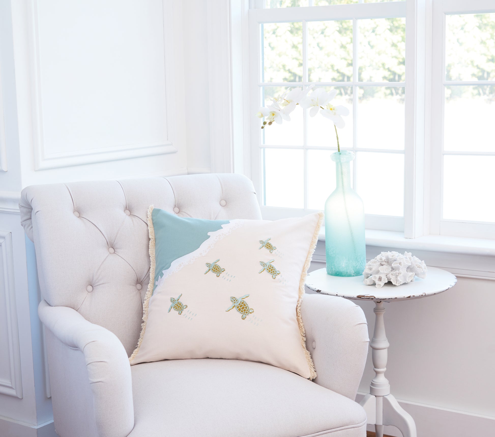 Turtle Migration Embroidered Pillow with Fringed Edges on Interior Chair