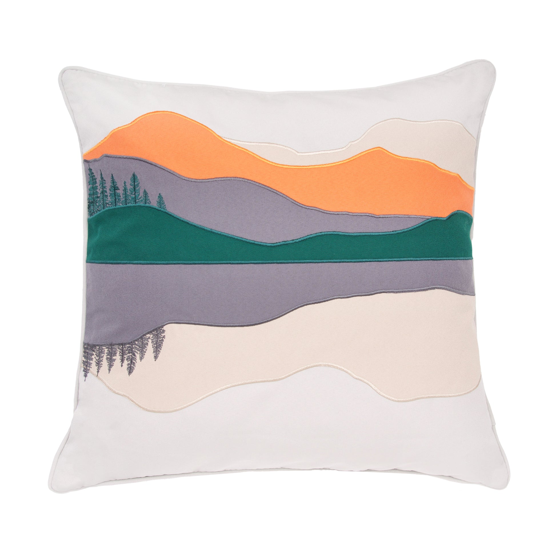 White pillow with an orange, green, and grey sunset with a few trees on the left