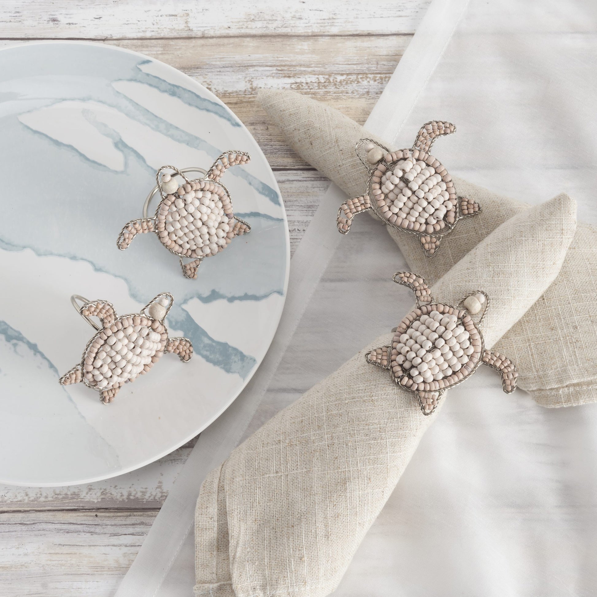 4 Sea Turtle shaped napkin rings crafted of natural beads. 