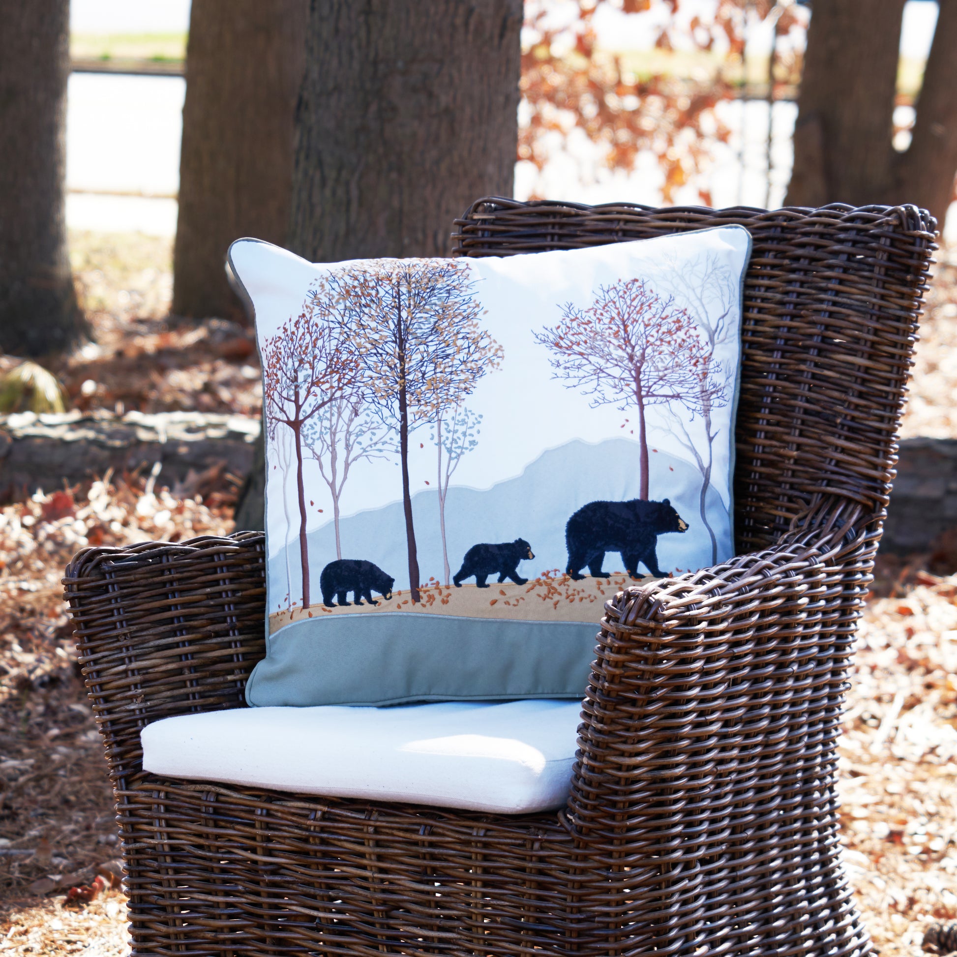 Woodland Bear Pillow outside on a chair