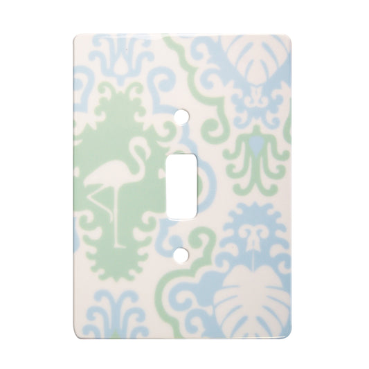 ceramic single toggle switchplate featuring printed green and light blue art deco design with palm leaf and flamingo silohuettes.