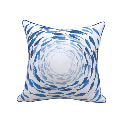 Embroidered fish in a blue ombre design, swirling from the corners into a circle within the middle of the pillow.