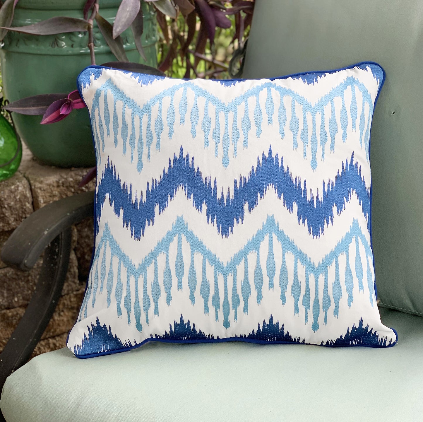 Beach House Ikat outdoor pillow styled on an outdoor couch.