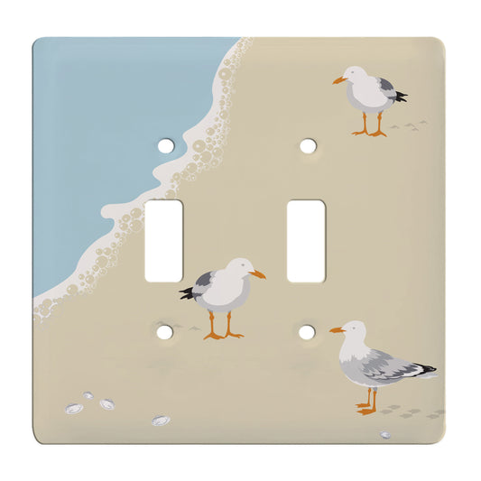 ceramic double toggle switchplate featuring seagulls standing on the beach.