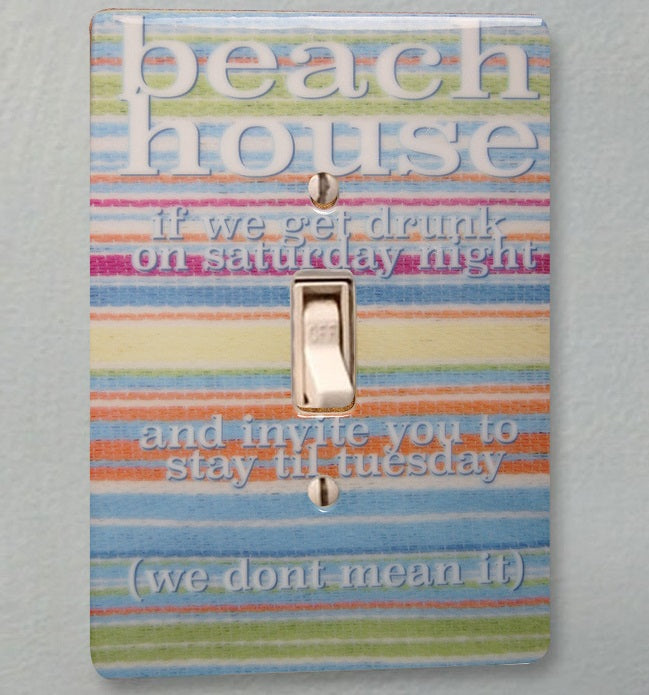 ceramic single toggle switchplate featuring a multi-colored striped background and text that reads "beach house if we get drunk on a saturday night and invite you to stay til tuesday (we dont mean it)".