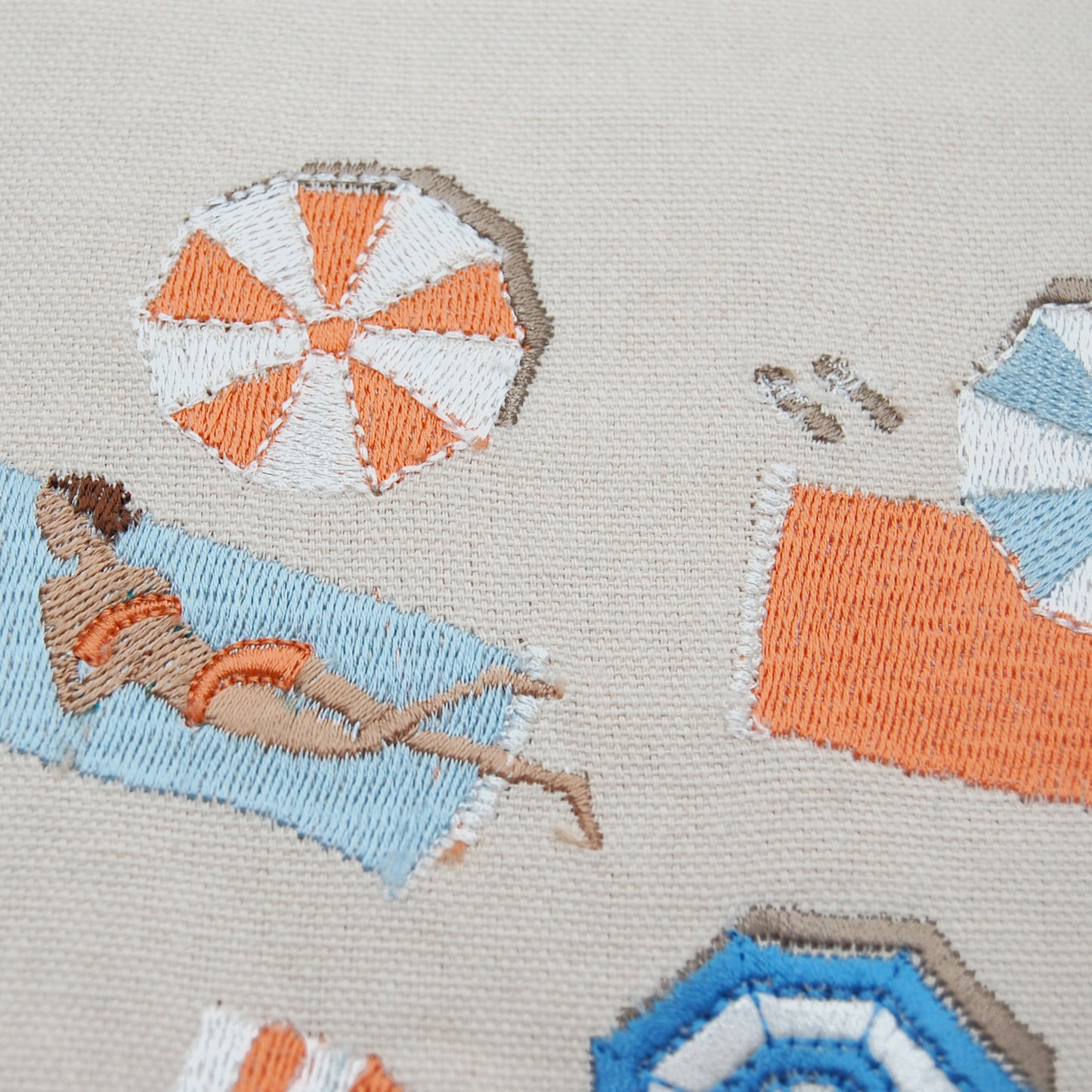 Close up shot on the embroidery work of Bird's Eye Beach Scene Pillow.
