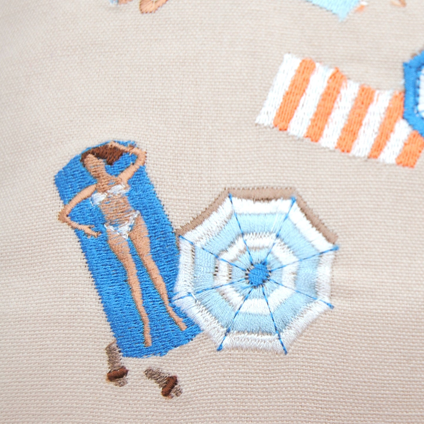 Close up shot on the embroidery work of Bird's Eye Beach Scene Pillow.