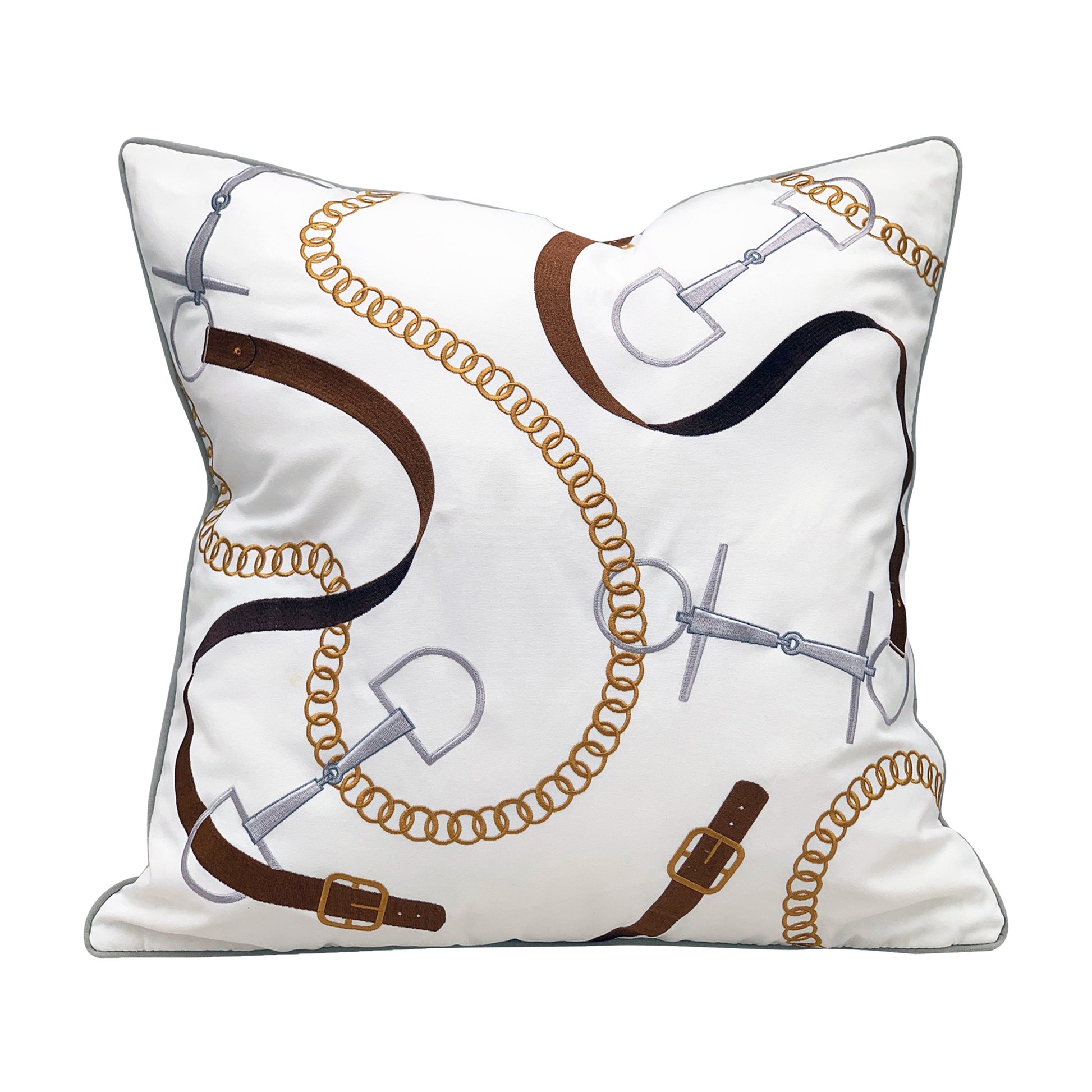 White ground pillow with embroidered equine bits & leather accessories.