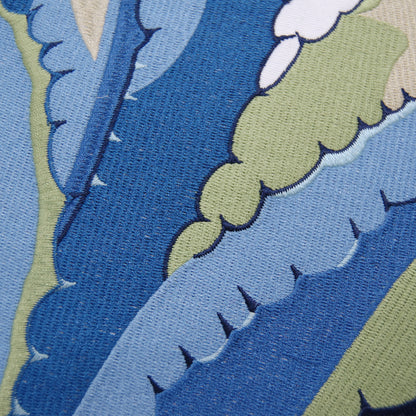Close up shot of the embroidery work on the Blue Agave Indoor Outdoor pillow.