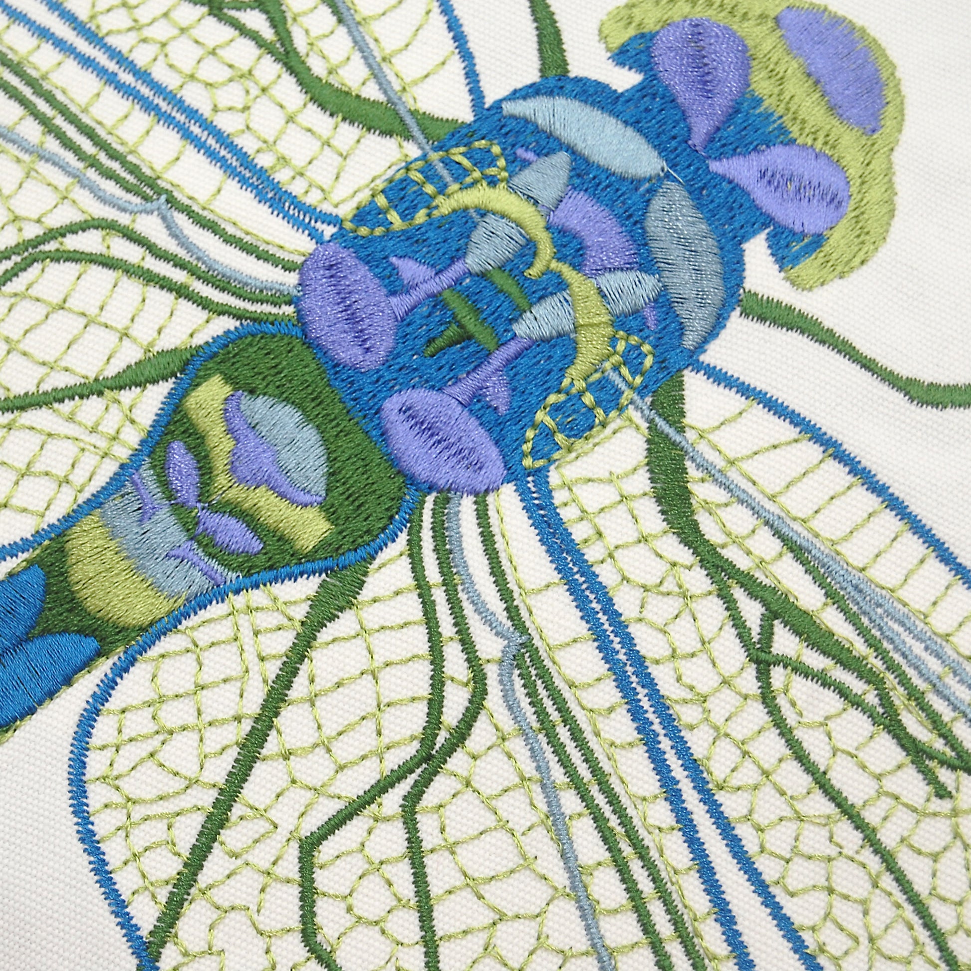 Detailed shot of the embroidery on the Blue Dragonfly Indoor Outdoor Pillow.