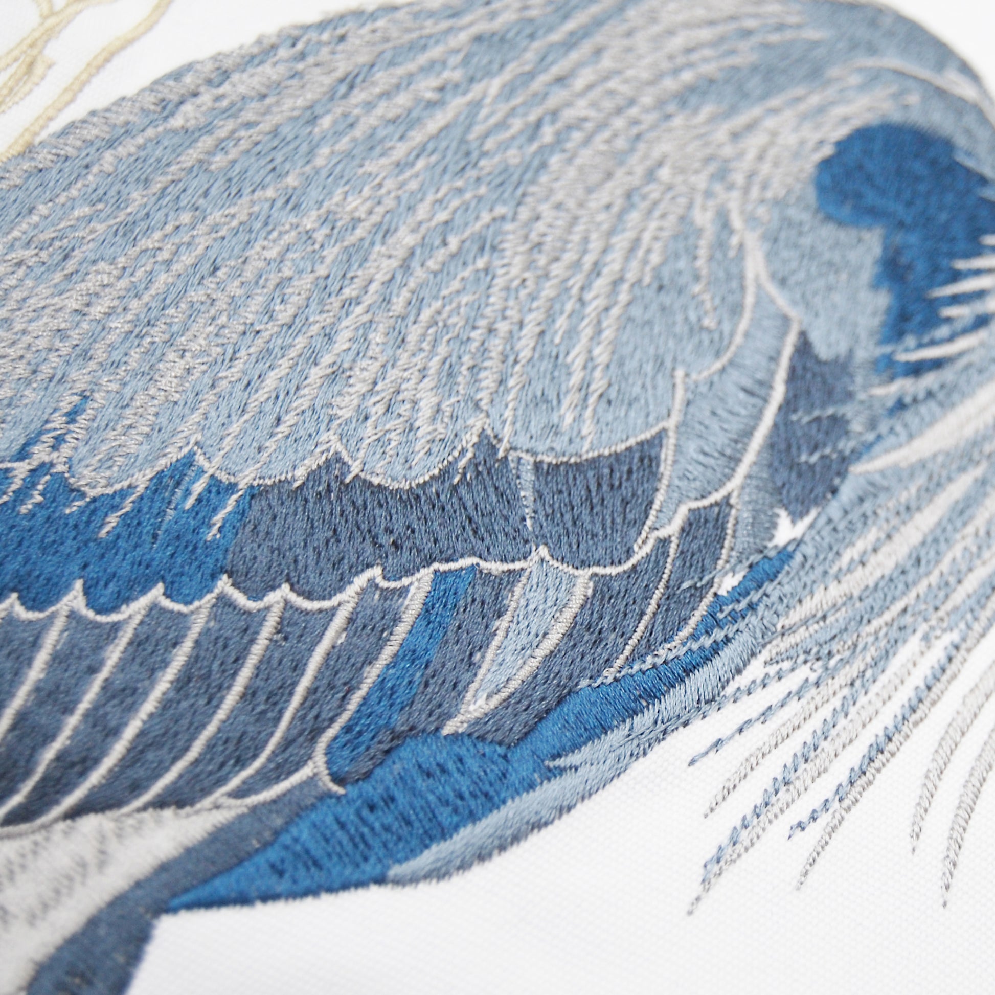 Detailed shot of the embroidery work on the blue herons feathers.