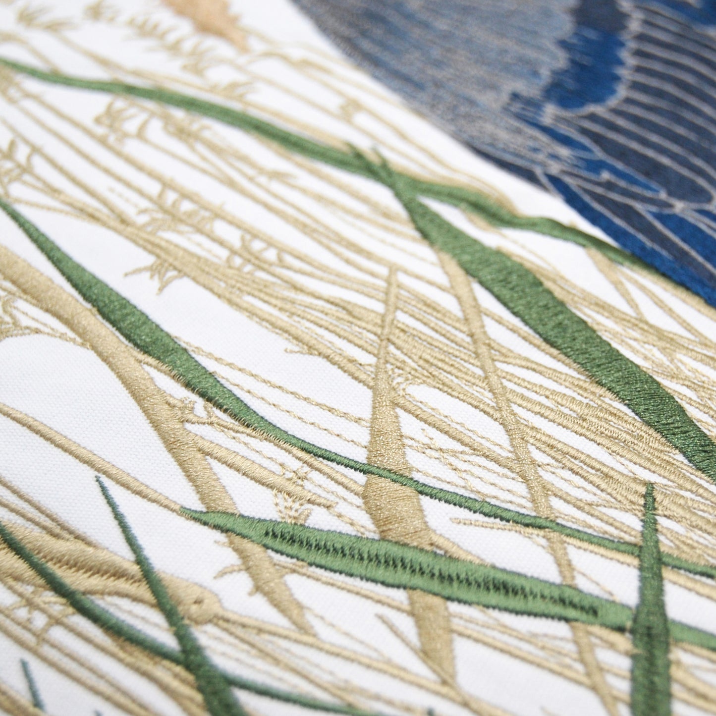 Detailed shot of the saltmarsh grass embroidery work on the Blue Heron and Saltmarsh Pillow.