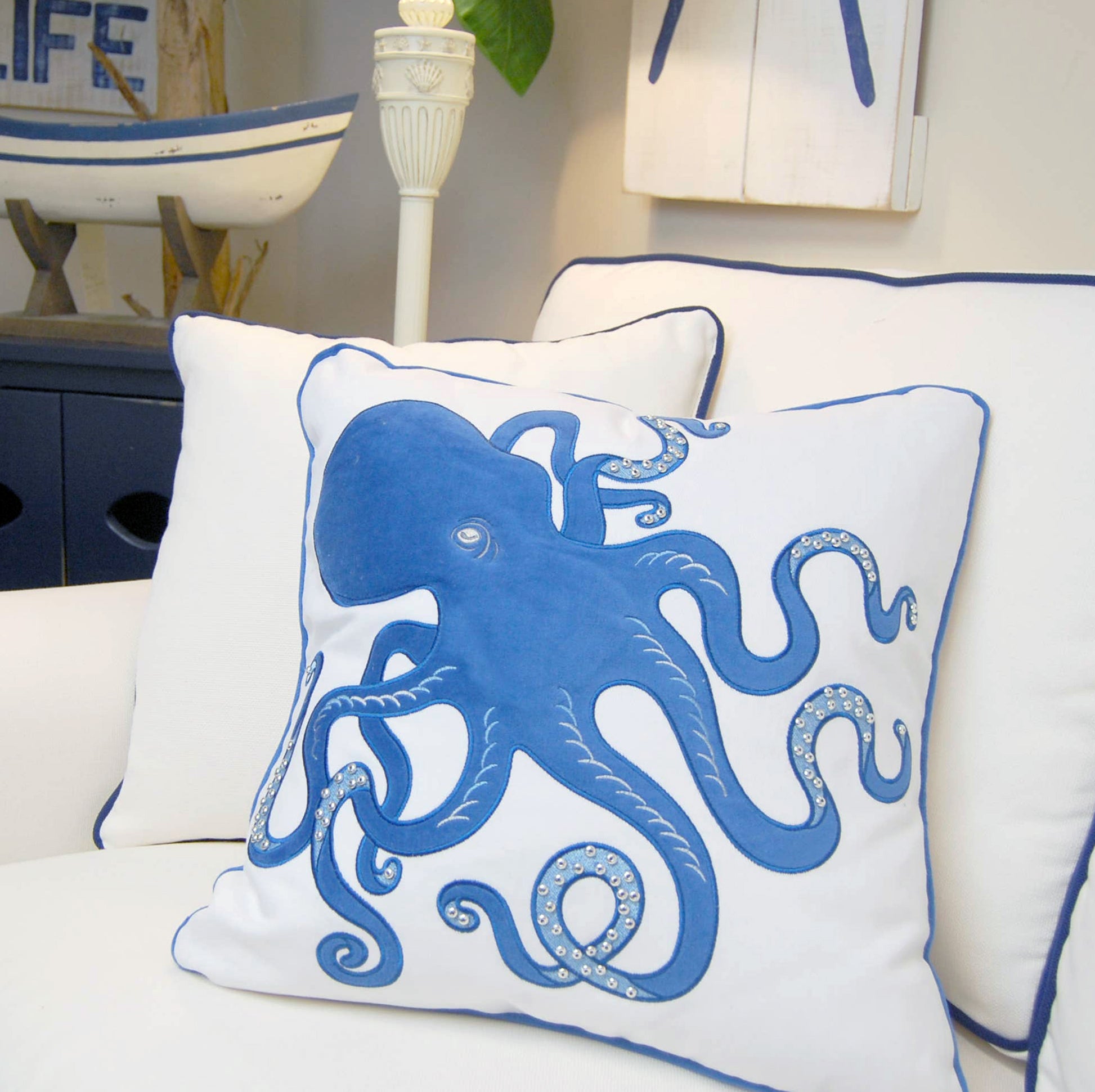 Blue Inkling Octopus indoor pillow styled in a coastal living room.