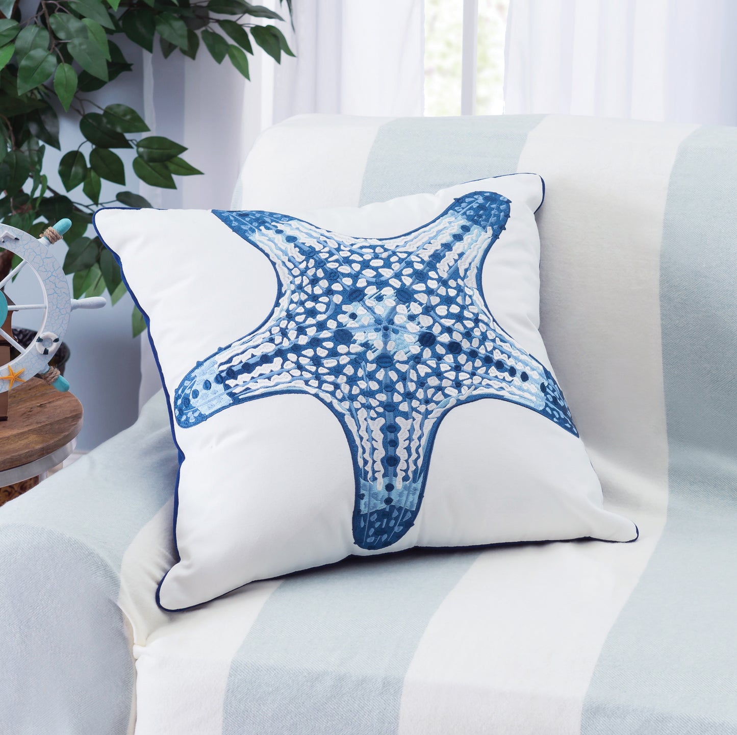 Blue Sea Star pillow styled in a coastal themed living room.