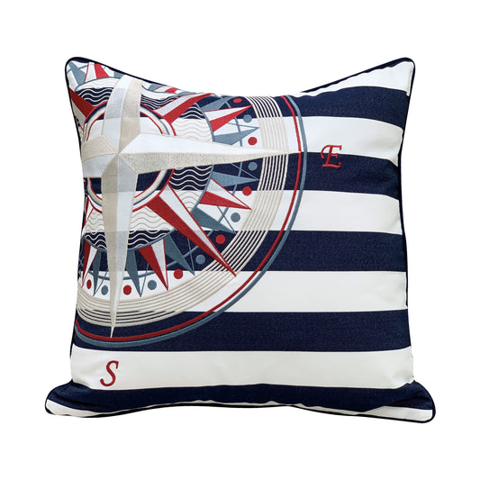 Compass embroidered in the left top corner of a navy and white striped pillow. Pillow finished with navy piped edging.