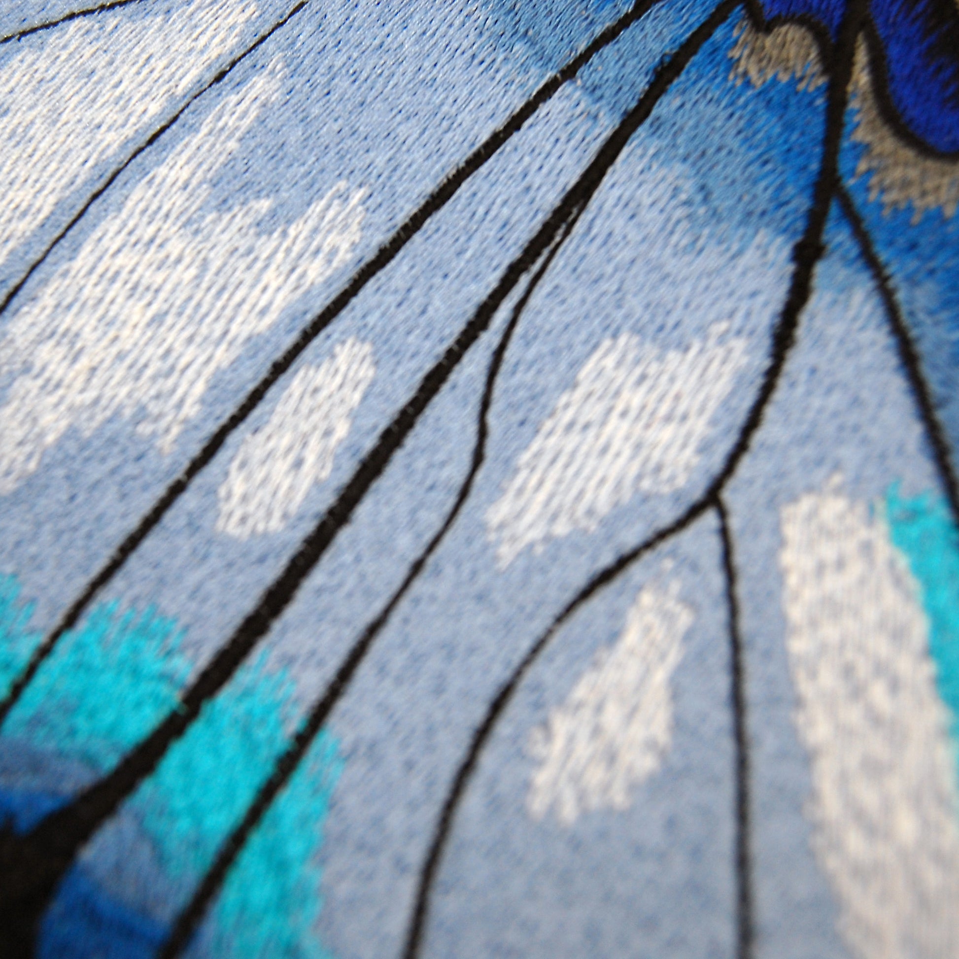 Detailed shot of the embroidery on the Bold Blue Butterfly pillow
