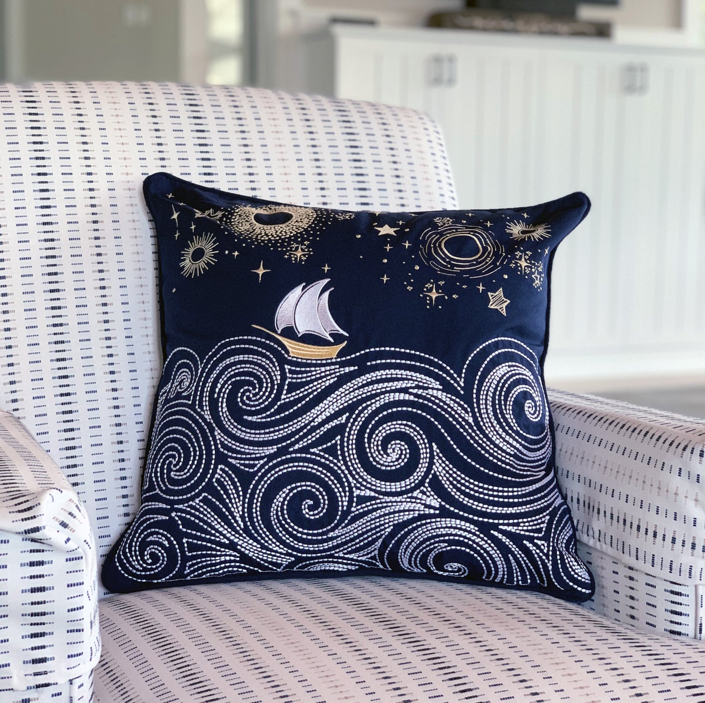 Cape Series Stormy Seas pillow styled on a patio chair.