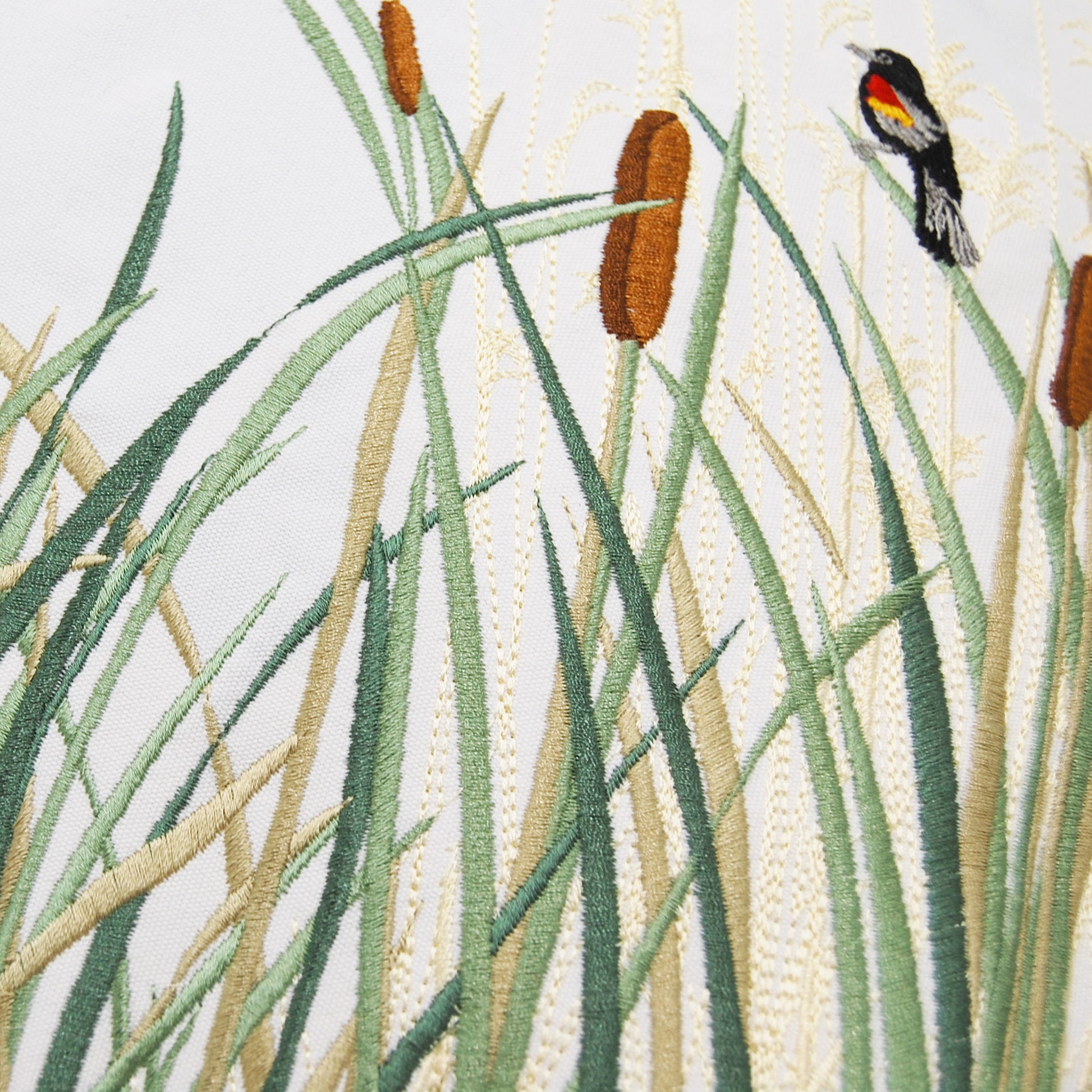 Detail shot of the embroidered design on the Cattails and Red Winged Pillow.