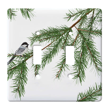 ceramic double toggle switch plate featuring chickadee bird sitting upon a pine tree branch.