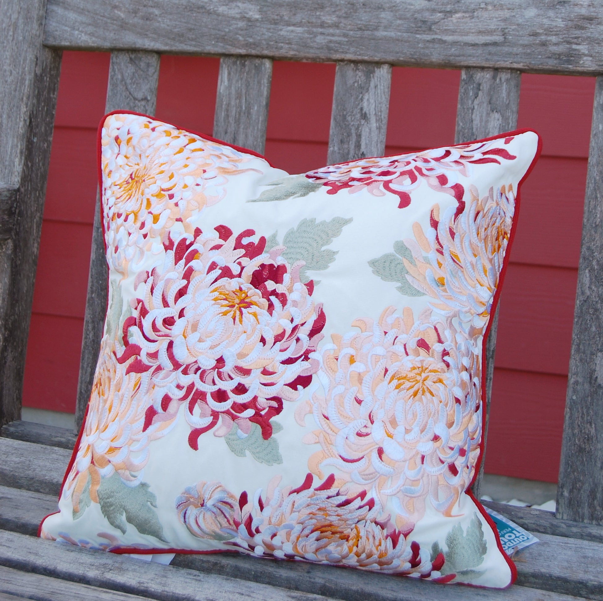 Chrysanthemum pillow styled on an outdoor bench.