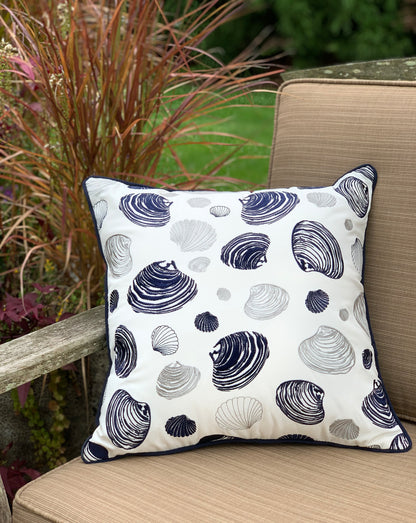 Clam Pattern pillow styled on an outdoor patio chair.