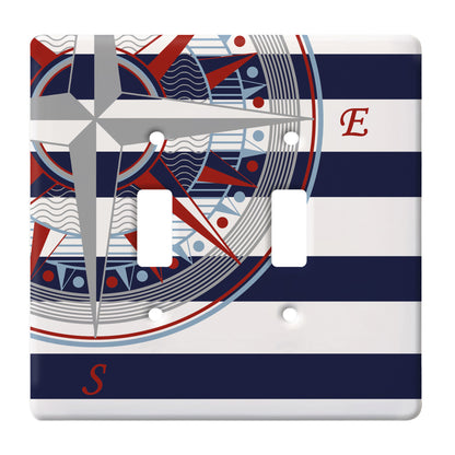 ceramic double toggle switch plate featuring navy and white stripes behind a nautical compass graphic.