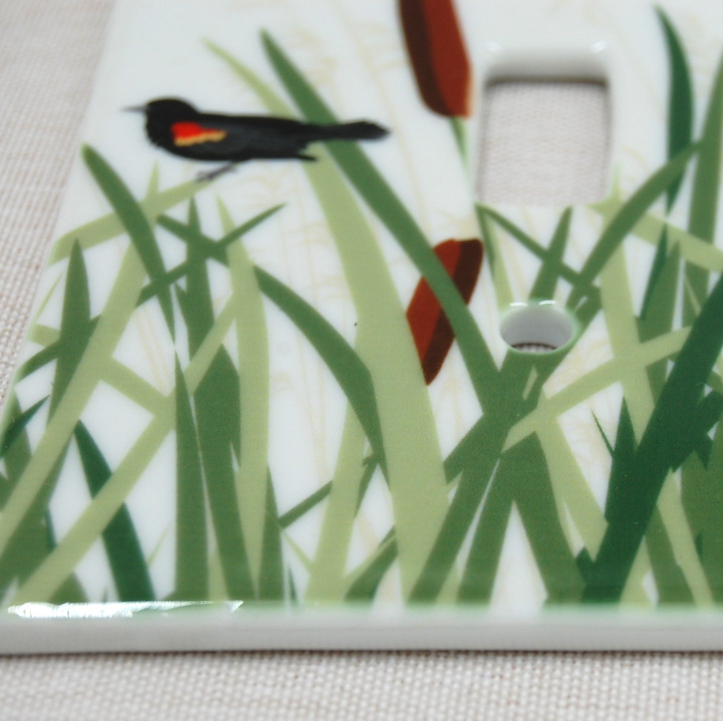 Detail shot of the Red Winged Blackbird porcelain switch plate
